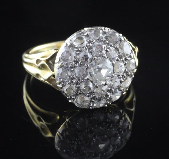 An early 20th century gold and pave set diamond cluster ring, size M